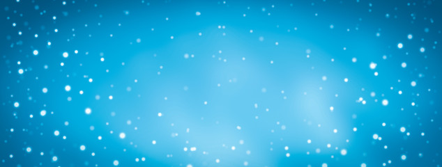 blurred glitter lights background with snow fall on blue background on Christmas holiday