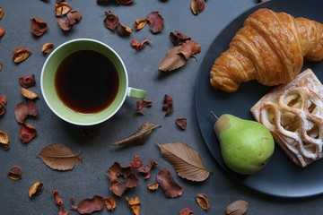 cup of coffee and fresh croissants, pear 