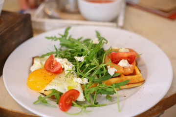 Belgian waffles with salad and eggs