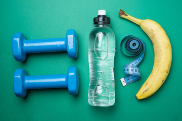 Fitness accessories, banana, on green background