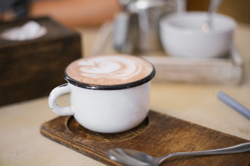 white cup of cocoa on a table