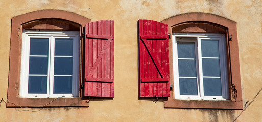 Windows with red shutters