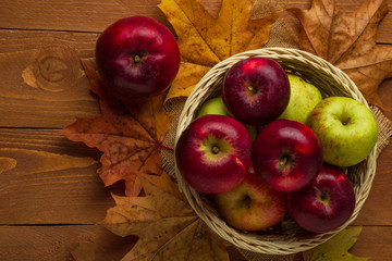 Still life with a view of a basket with red autumn apples, top view