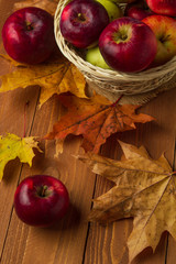 Still life with a view of a basket with red autumn apples