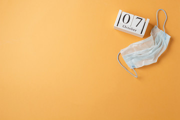 World physician day in 2019, october 11, calendar and medical mask, on orange background