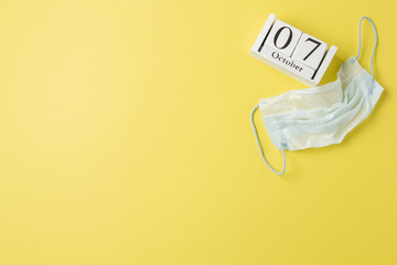 World doctor's day in 2019, October 11, calendar and medical mask, on a yellow background