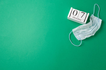 World physician day in 2019, october 11, calendar and medical mask, on green background