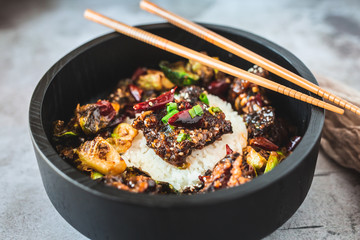General Tso's Chicken with steamed rice and chopsticks 