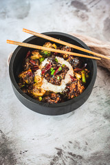 General Tso's Chicken with steamed rice and chopsticks 