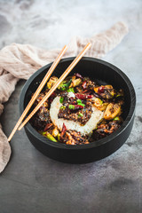 General Tso's Chicken with steamed rice and chopsticks 