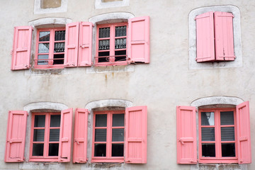 beautiful facade with pink windows and shutters