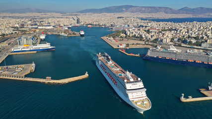 Aerial photo of luxury cruise liner leaving famous busy port of Piraeus one of the largest in...