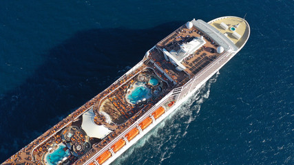 Aerial photo of large cruise liner ship cruising deep blue open ocean sea