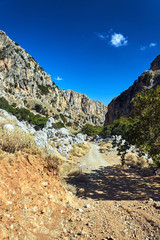 Road in rocky slope Deliana gorge on the island of Crete.