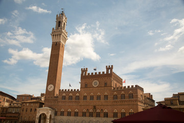 Fototapeta na wymiar Siena townhall under blue sky, with tower of Mangia
