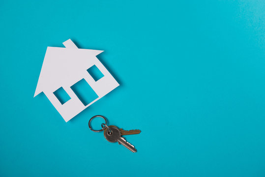 Silver key with house figure
