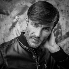 Portrait of a businessman who is looking into the camera, closeup.