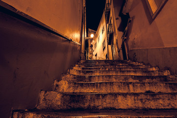 night landscape of Lisbon street with stairs next to Lisbon Cathedral. City of Lisbon in Portugal...