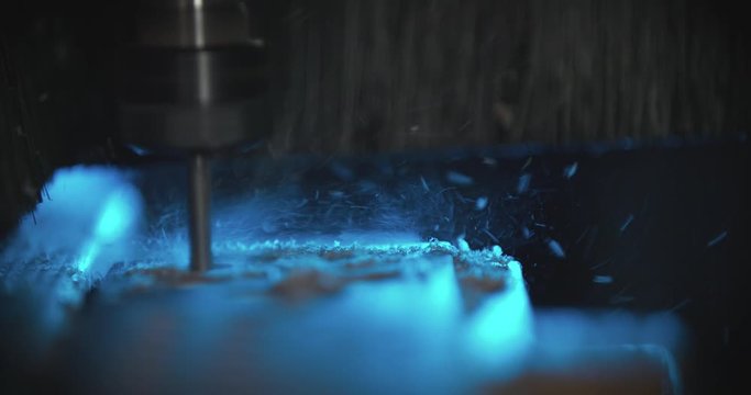 Close up slow motion shot, drilling, milling machine with CNC cutting the wooden piece.