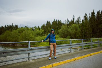 male tourist standing beside the mountain river