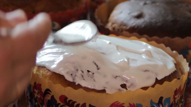 anoint the Easter cake with icing,spoon with white icing Easter cake, decorate Easter cake with sweet icing