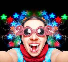 Two thousand twenty. New Years concept. Girl in glasses taking selfie.