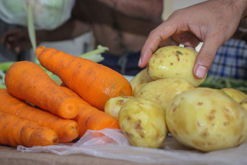 Cleaning the potatoes which are going to be cooked