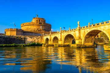 Castle Sant Angelo (Mausoleum of Hadrian), bridge Sant Angelo and river Tiber in the rays of sunset...