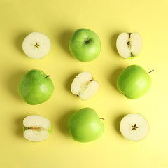 Flat lay composition of fresh ripe green apples on yellow background