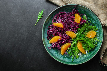 healthy salad red cabbage, arugula, orange fillet (delicious snack, mix leaves lettuce, coleslaw) menu concept. food background. copy space. Top view