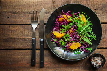 healthy salad red cabbage, arugula, orange fillet (delicious snack, mix leaves lettuce, coleslaw) menu concept. food background. copy space. Top view