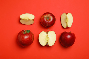 Flat lay composition with ripe juicy apples on red background