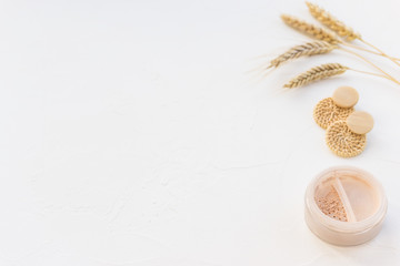 Mineral loose powder for makeup on a white background.  Copy space, horizontal orientation.