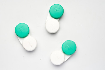 Contact lens containers on a white background.