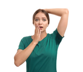 Young woman with sweat stain on her clothes against white background. Using deodorant