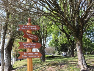 Plaque in Praça das Flores signaling the location of the covered street, green maze, toilets and information.