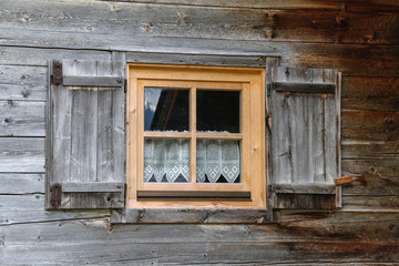 Windows with shutters in a wooden house