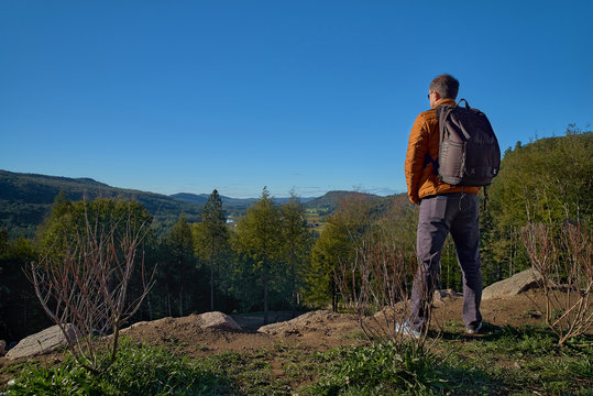 30 Year Old Man Resting Outdoors In The Mountains, Standing Far On The Trail, Looking Into The Distance In A Forest, In Quebec Harrington. Travel To Canada