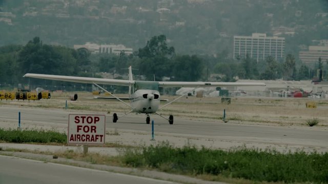 Small generic private propeller airplane preparing for take-off. 60 FPS Slow Motion, 4K RAW graded footage