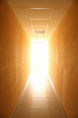 Long narrow tunnel with light in the end as abstract concept of something inevitable