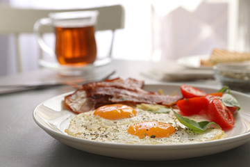 Tasty breakfast with fried eggs on grey table, closeup
