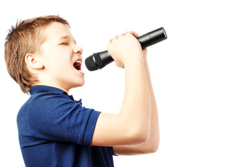 Teenage boy singing into a microphone. Very emotional.