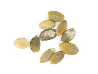 Raw peeled pumpkin seeds on white background, top view