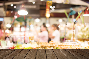 Supermarket blur with wood background