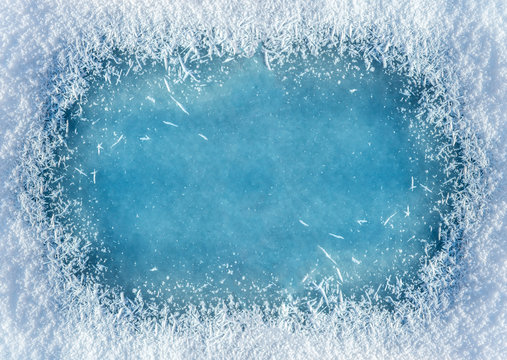 Winter background: close-up of frozen ice with snow crystals and snowflakes. Christmas and Happy New Year frame background with copyspace. Ice and snow texture