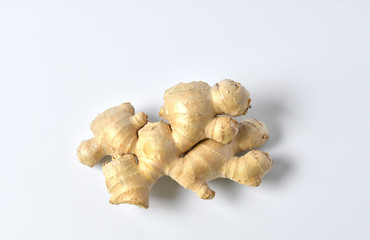 Fresh ginger root on a white background