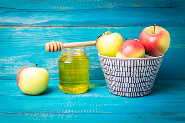 Jar of honey and apples on the table for the holiday of Rosh Hashanah