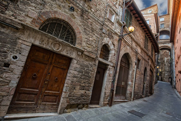Fototapeta na wymiar Ancient monumental architecture in Perugia.Narrow streets, arches and old buildings in the historic center of beautiful town of Perugia, in Umbria, Italy