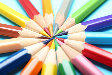 Fototapeta premium Composition with colorful pencils on light blue background, closeup