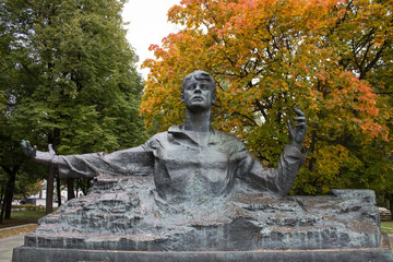 monument to Sergei Yesenin against a bright autumn tree in Ryazan Russia